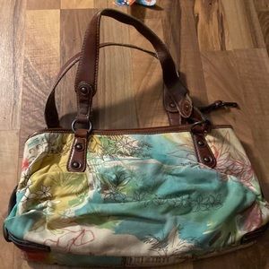 Purse with multi color and several pockets but has little black spot on inside